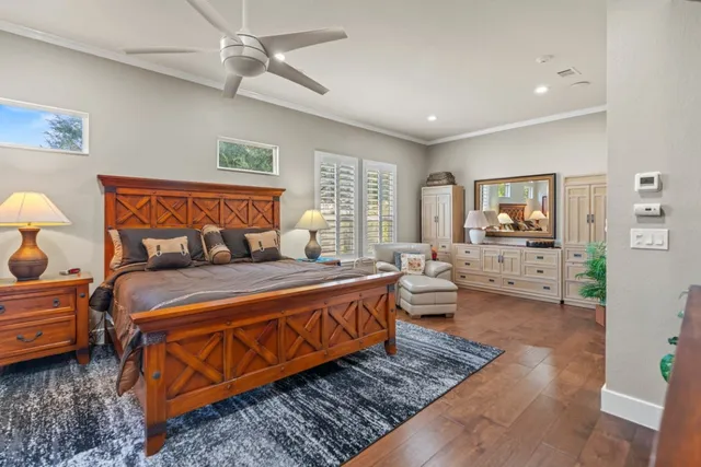 a bedroom with a bed and glass windows