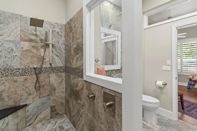 a bathroom with a toilet and a shower