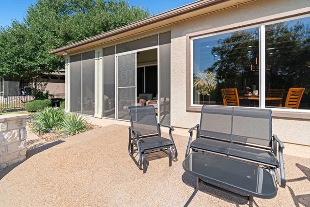 a view of a patio with table and chairs