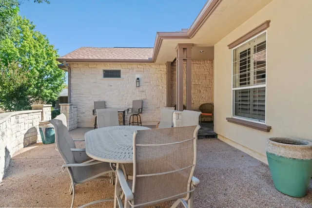 a view of a dining room with furniture a chandelier and wooden floor