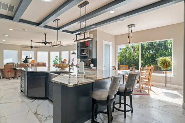 a dining area with granite countertop a table chairs and wooden floor