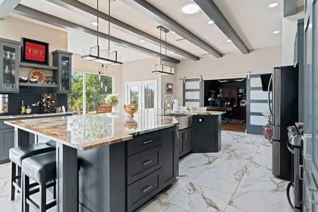 a kitchen with a counter space a sink appliances and cabinets
