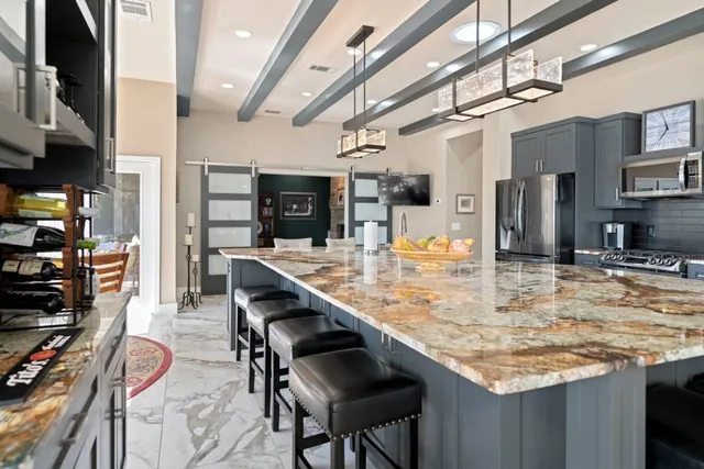 a kitchen with stainless steel appliances granite countertop a sink and cabinets