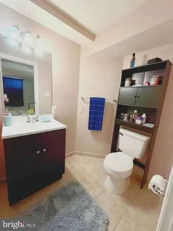 a bathroom with a sink vanity mirror and toilet