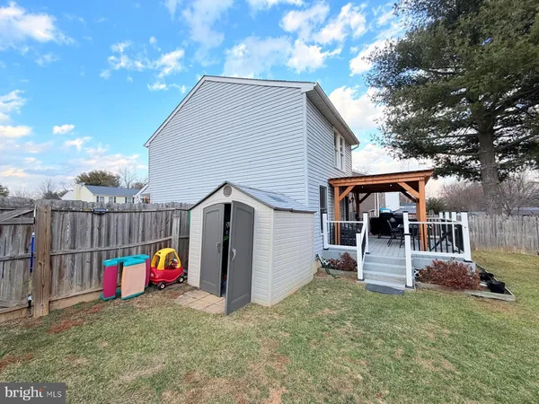a view of a house with a backyard and a tree