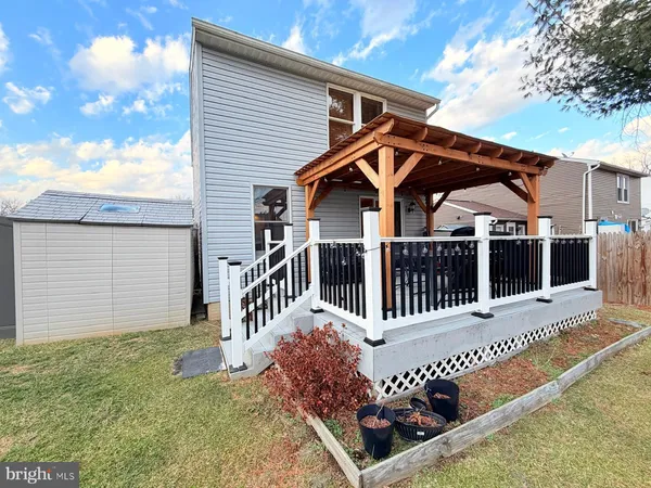 a view of a house with wooden fence