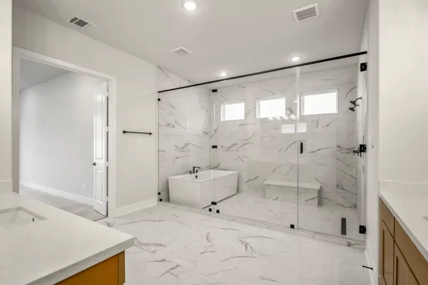 a bathroom with a bathtub and a shower