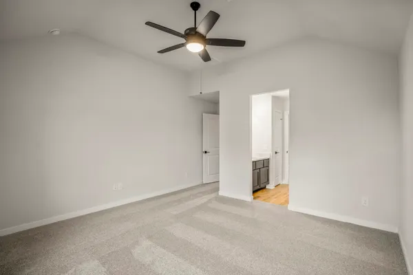 an empty room with a ceiling fan and a window