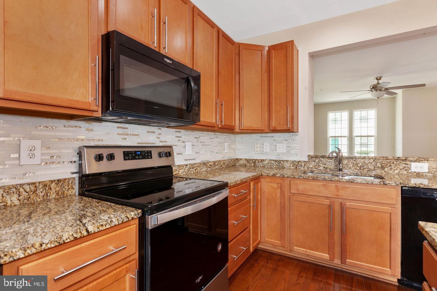 9418 Paragon Court Owings Mills, MD 21117 - Photo 14 of 42 a kitchen with stainless steel appliances a stove microwave and sink