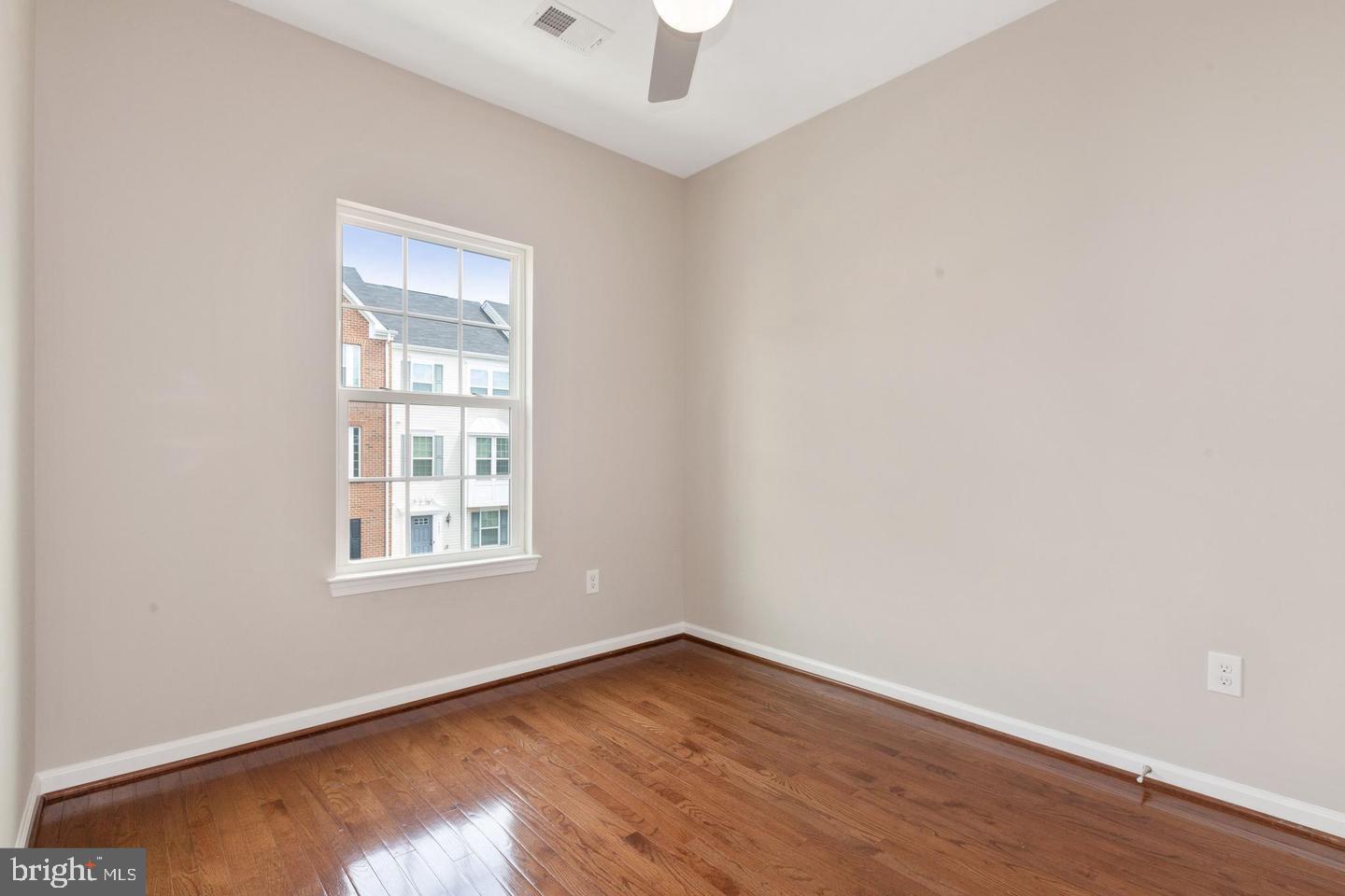 9418 Paragon Court Owings Mills, MD 21117 - Photo 17 of 42 an empty room with wooden floor and windows