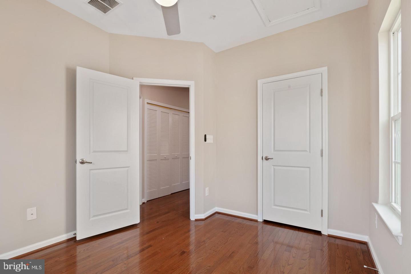 9418 Paragon Court Owings Mills, MD 21117 - Photo 20 of 42 an empty room with wooden floor & closet and windows