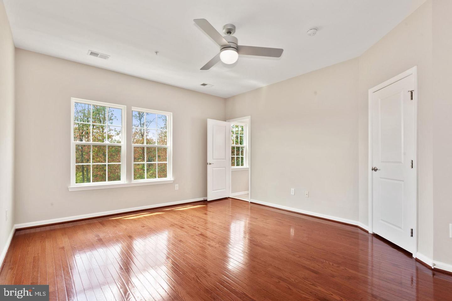 9418 Paragon Court Owings Mills, MD 21117 - Photo 22 of 42 wooden floor in an empty room with a window