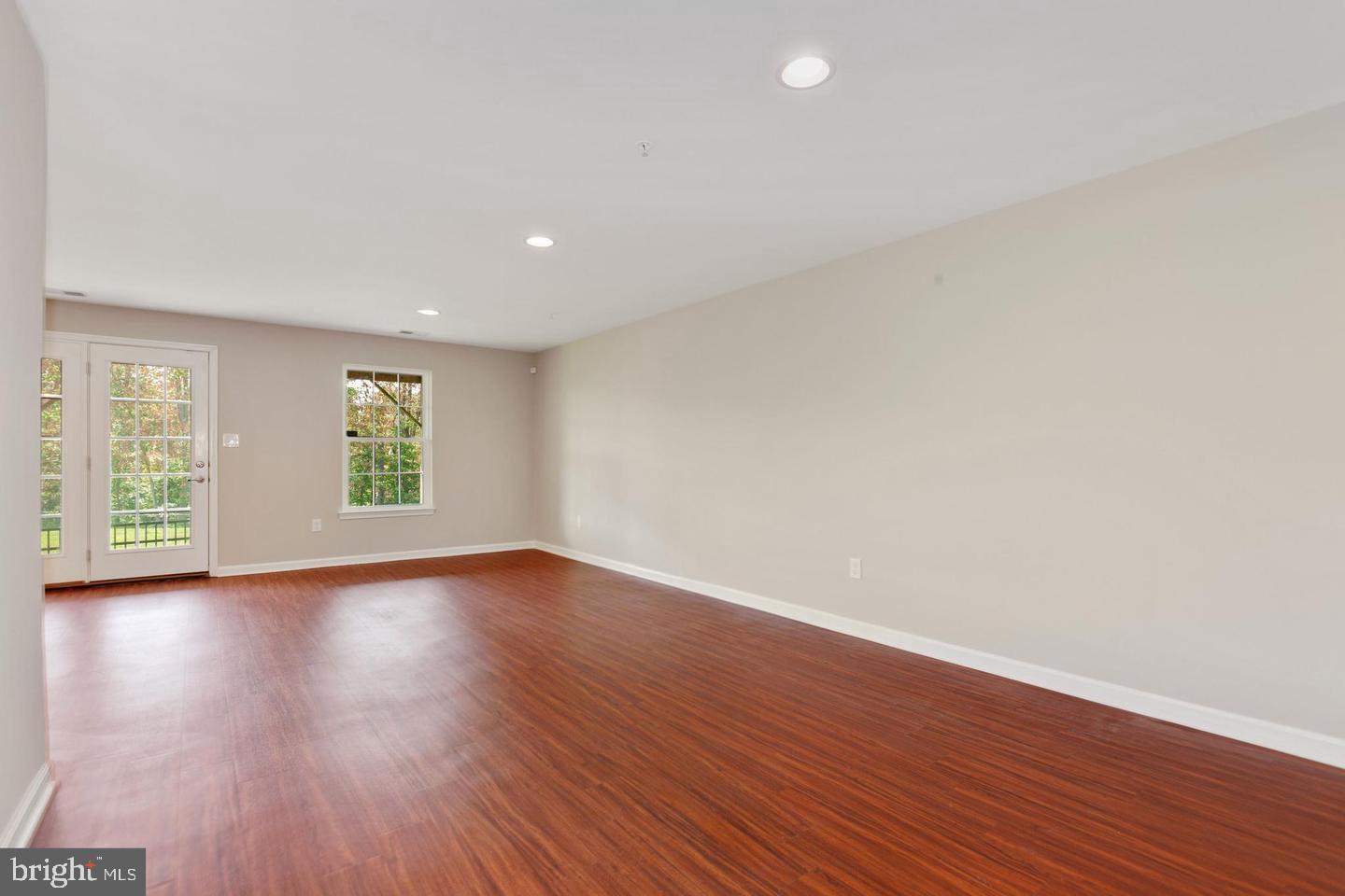 9418 Paragon Court Owings Mills, MD 21117 - Photo 30 of 42 a view of an empty room with wooden floor and windows