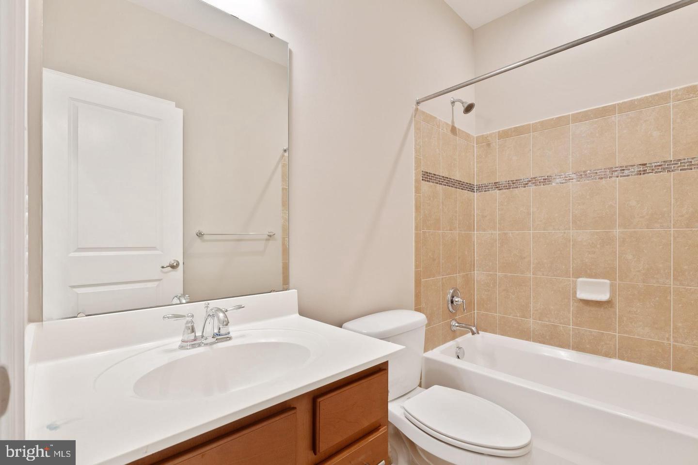 9418 Paragon Court Owings Mills, MD 21117 - Photo 35 of 42 a bathroom with a granite countertop sink toilet tub and shower