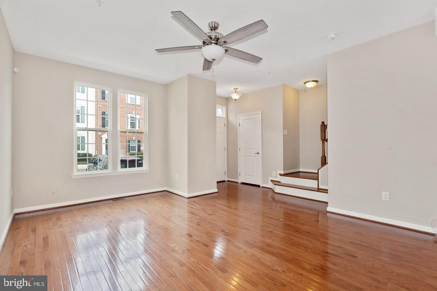 9418 Paragon Court Owings Mills, MD 21117 - Photo 5 of 42 an empty room with wooden floor and windows