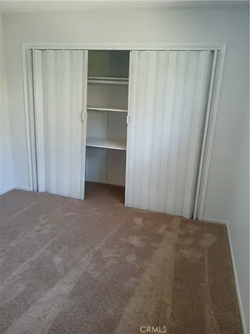 a view of an empty room with walk in closet