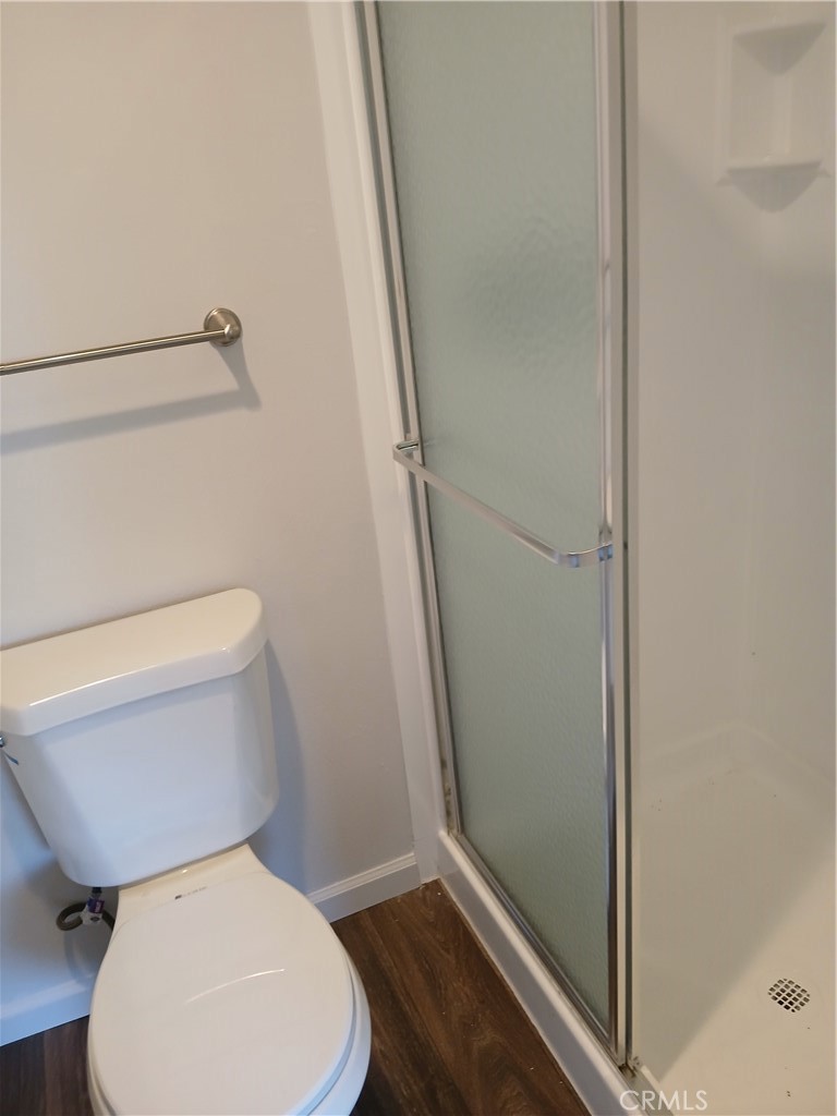 453 East 1st Street Tustin, CA 92780 - Photo 14 of 16 a white toilet sitting next to a shower