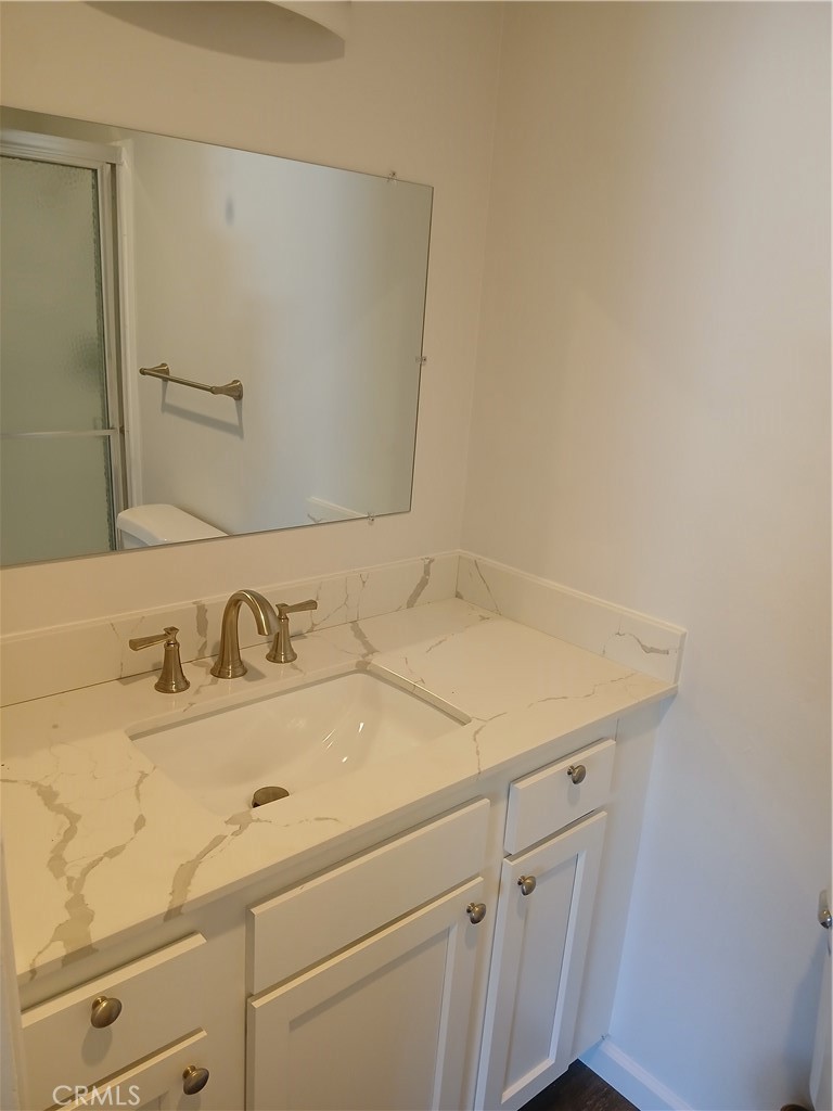 453 East 1st Street Tustin, CA 92780 - Photo 15 of 16 a bathroom with a sink and a mirror