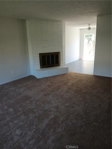 a view of empty room with a fireplace