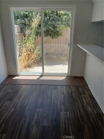 a view of wooden floor and brick walls