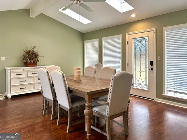 a view of kitchen with wooden floor and electronic appliances