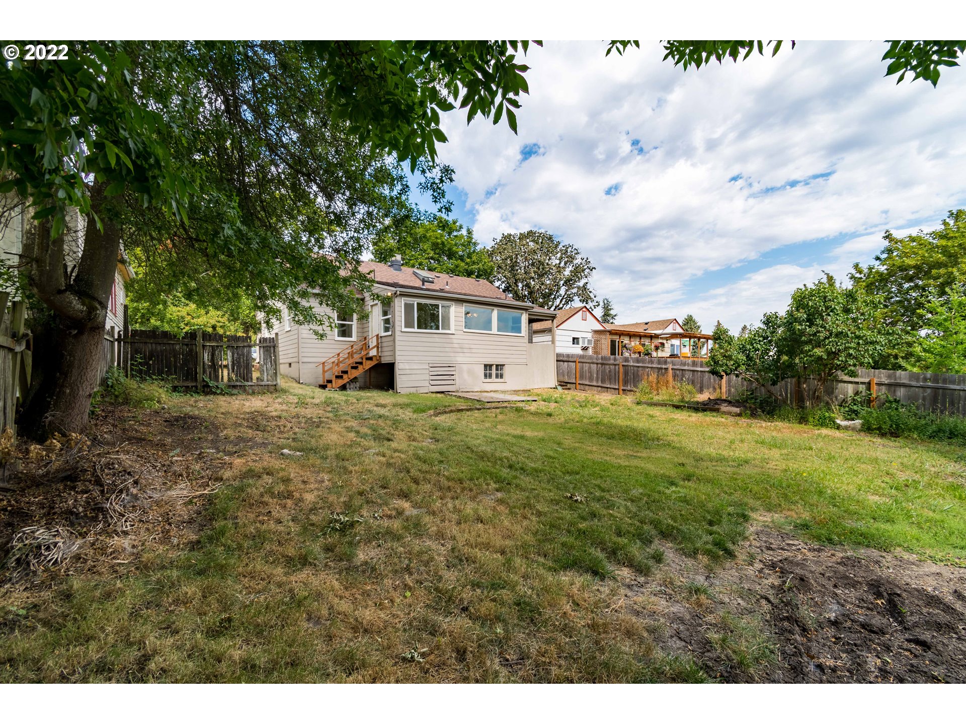 2175 City View Street Eugene, OR 97405 - Photo 29 of 32 a view of a white house next to a yard with big trees
