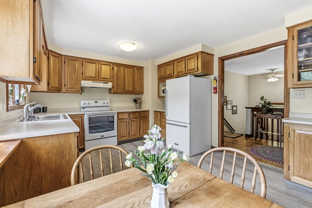 788 Burts Pit Road Northampton, MA 01062 - Photo 11 of 42 a kitchen with stainless steel appliances granite countertop a refrigerator a stove a sink dishwasher with a dining table and chairs
