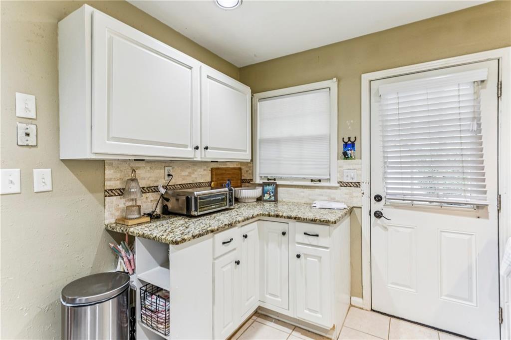 2592 Woodacres Road Northeast Atlanta, GA 30345 - Photo 16 of 27 a kitchen with a sink stove and cabinets