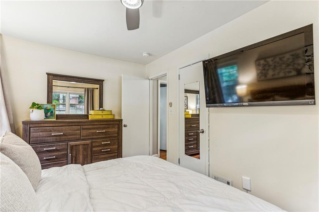 2592 Woodacres Road Northeast Atlanta, GA 30345 - Photo 18 of 27 a bedroom with a bed and a flat screen tv