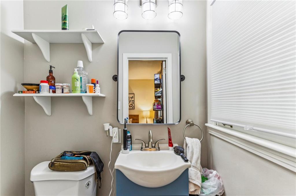 2592 Woodacres Road Northeast Atlanta, GA 30345 - Photo 19 of 27 a bathroom with a sink a toilet and a mirror