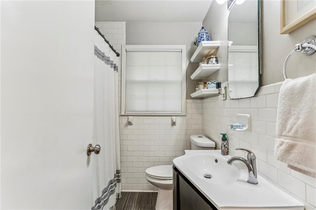 2592 Woodacres Road Northeast Atlanta, GA 30345 - Photo 22 of 27 a bathroom with a sink a toilet and shower
