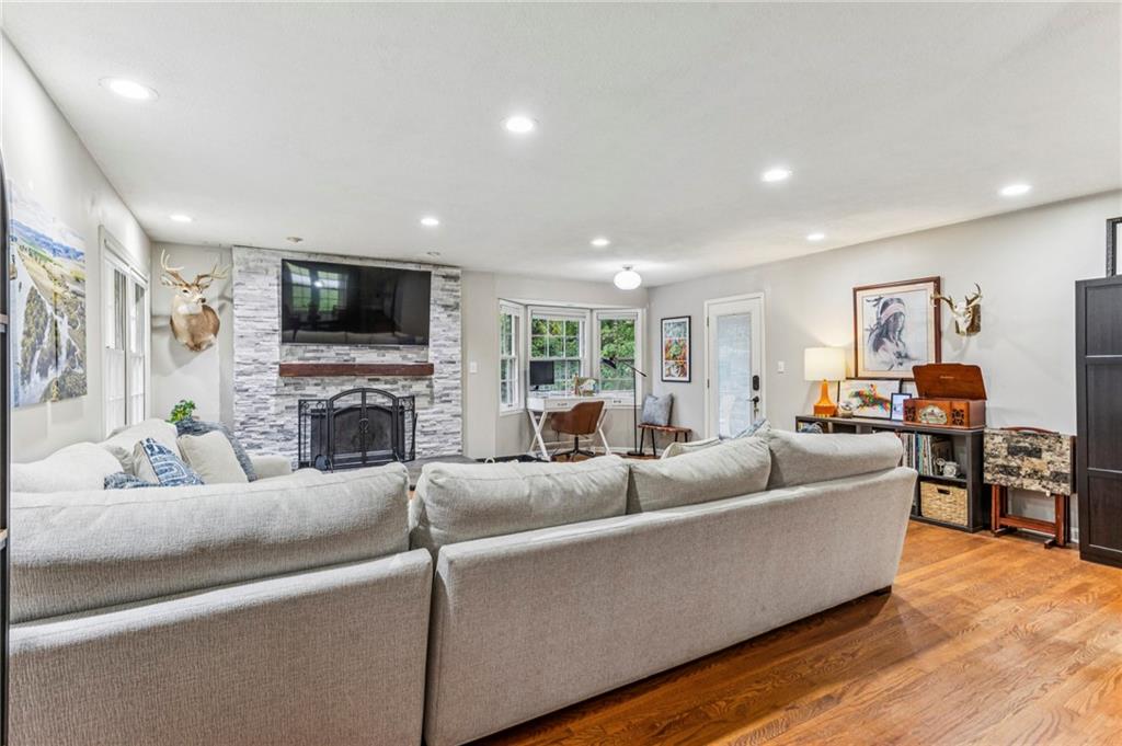 2592 Woodacres Road Northeast Atlanta, GA 30345 - Photo 9 of 27 a living room with furniture a fireplace a flat screen tv and a window