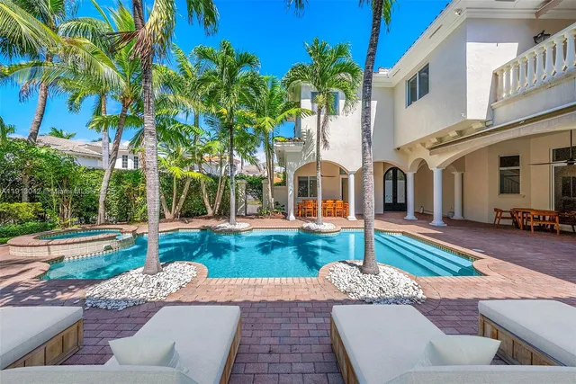 a view of a house with swimming pool and porch with furniture