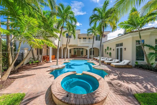 a swimming pool with outdoor seating and yard