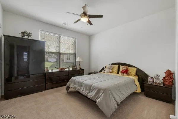a living room with furniture and a painting on the wall