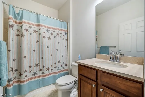 a view of a dining room with furniture and a chandelier