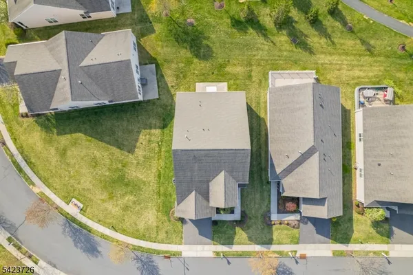 an aerial view of residential houses with outdoor space and swimming pool