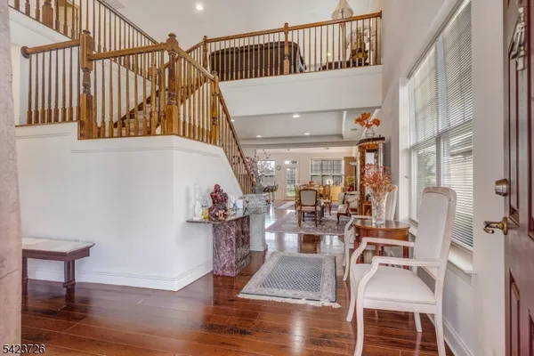 a view of a big house with a big yard and large trees