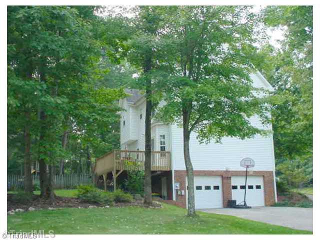 110 Harper Ridge Court Clemmons, NC 27012 - Photo 15 of 16 Exterior Back. Enjoy extended entertaining on the rear deck & patio overlooking a partially fenced backyard with playground area.