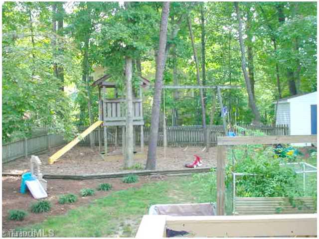 110 Harper Ridge Court Clemmons, NC 27012 - Photo 16 of 16 Exterior Back. Nice fenced year area for a pet, playground area and storage building
