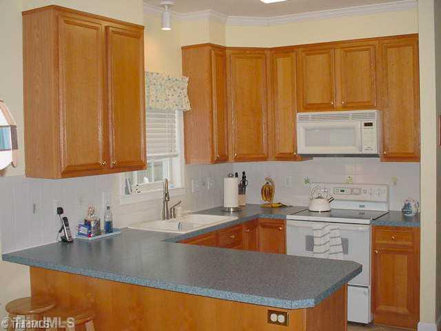 110 Harper Ridge Court Clemmons, NC 27012 - Photo 4 of 16 Kitchen. Kitchen features white appliances & backsplash and bar seating.