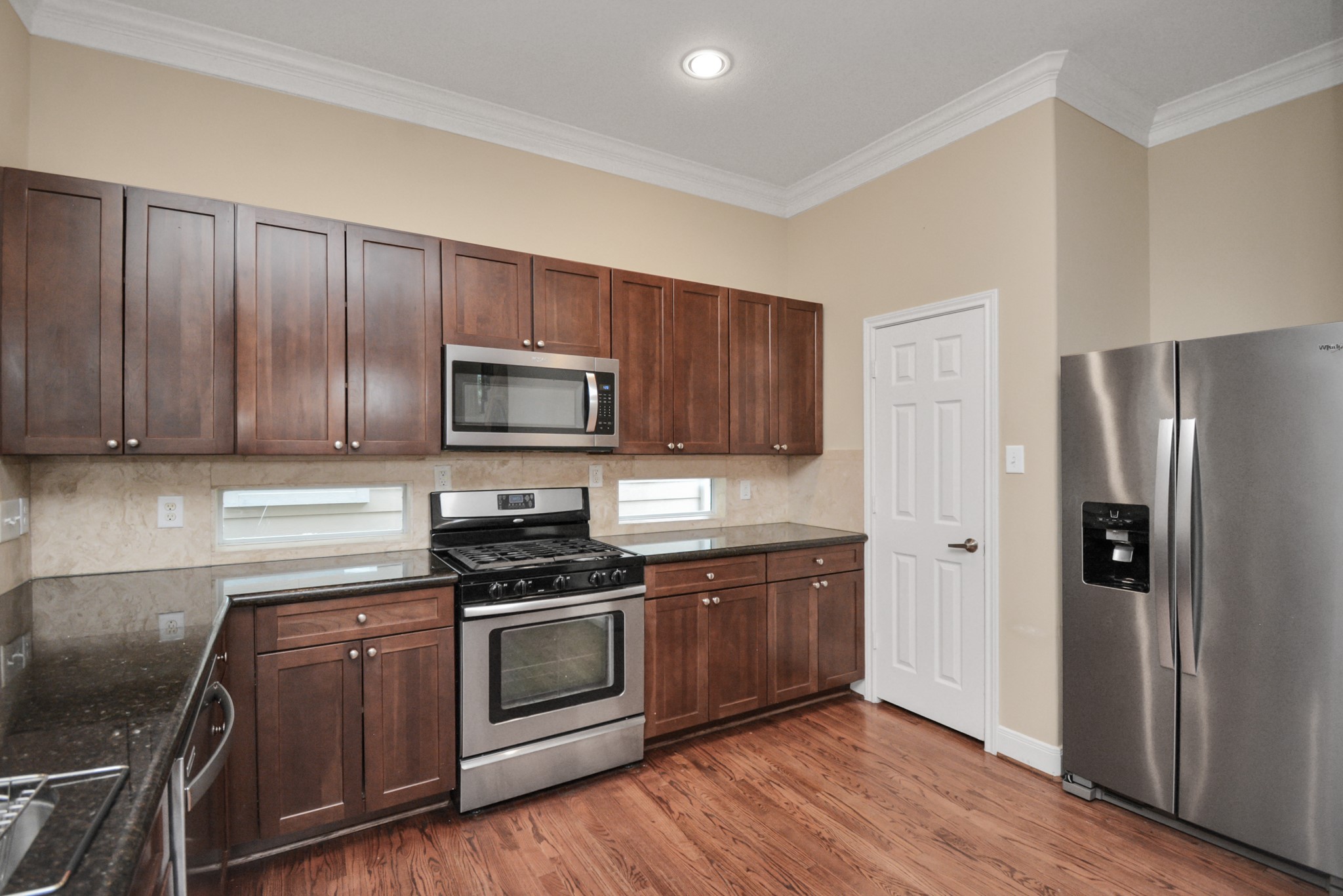 1137 West 24th Street, Unit A Houston, TX 77008 - Photo 8 of 40 a kitchen with sink a microwave and refrigerator