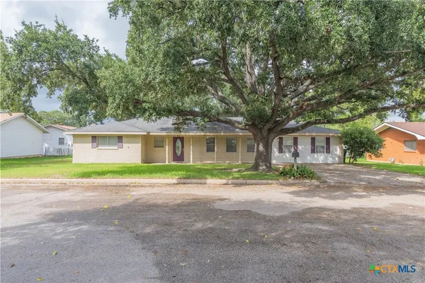 a front view of house with yard and green space