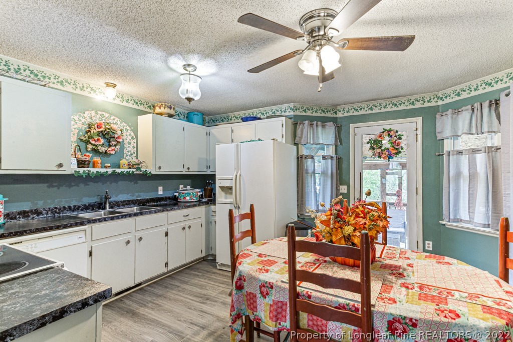 400 Evans Drive Cameron, NC 28326 - Photo 7 of 15 a kitchen with stainless steel appliances kitchen island granite countertop a refrigerator and a stove