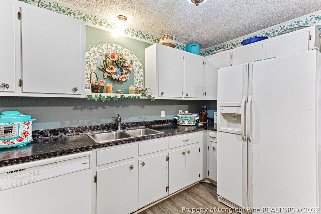 400 Evans Drive Cameron, NC 28326 - Photo 9 of 15 a kitchen with stainless steel appliances white cabinets and a refrigerator a sink