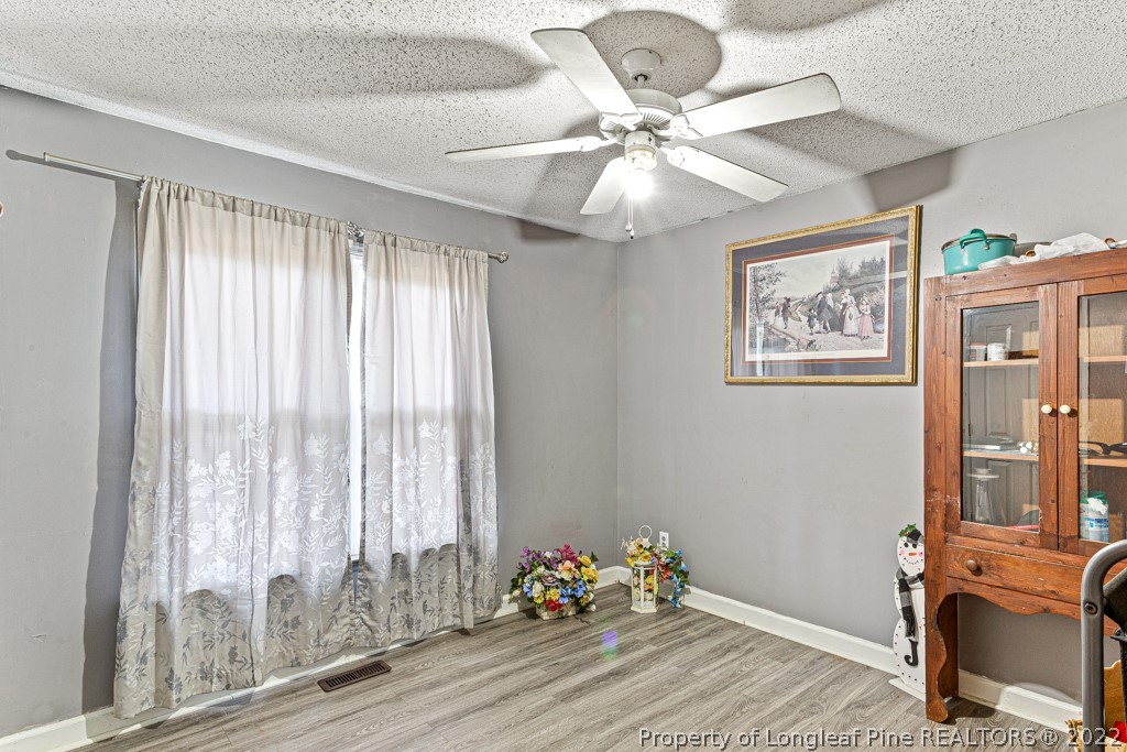 400 Evans Drive Cameron, NC 28326 - Photo 10 of 15 a room with chandelier fan and windows