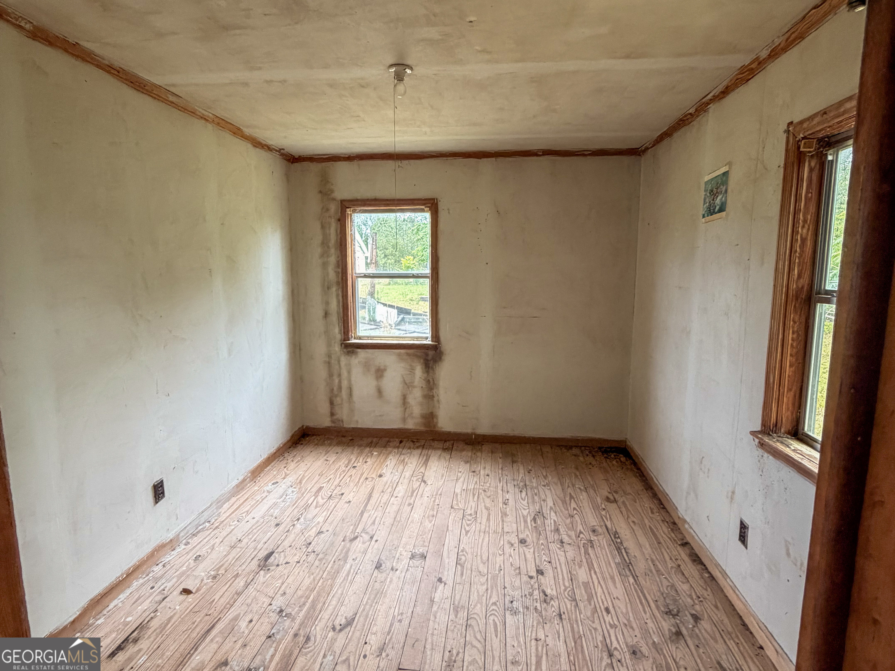 3925 Highway 441 Rentz, GA 31075 - Photo 12 of 16 an empty room with wooden floor and windows