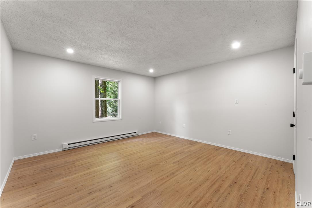4121 Romeo Road Tobyhanna, PA 18466 - Photo 11 of 24 an empty room with wooden floor and windows