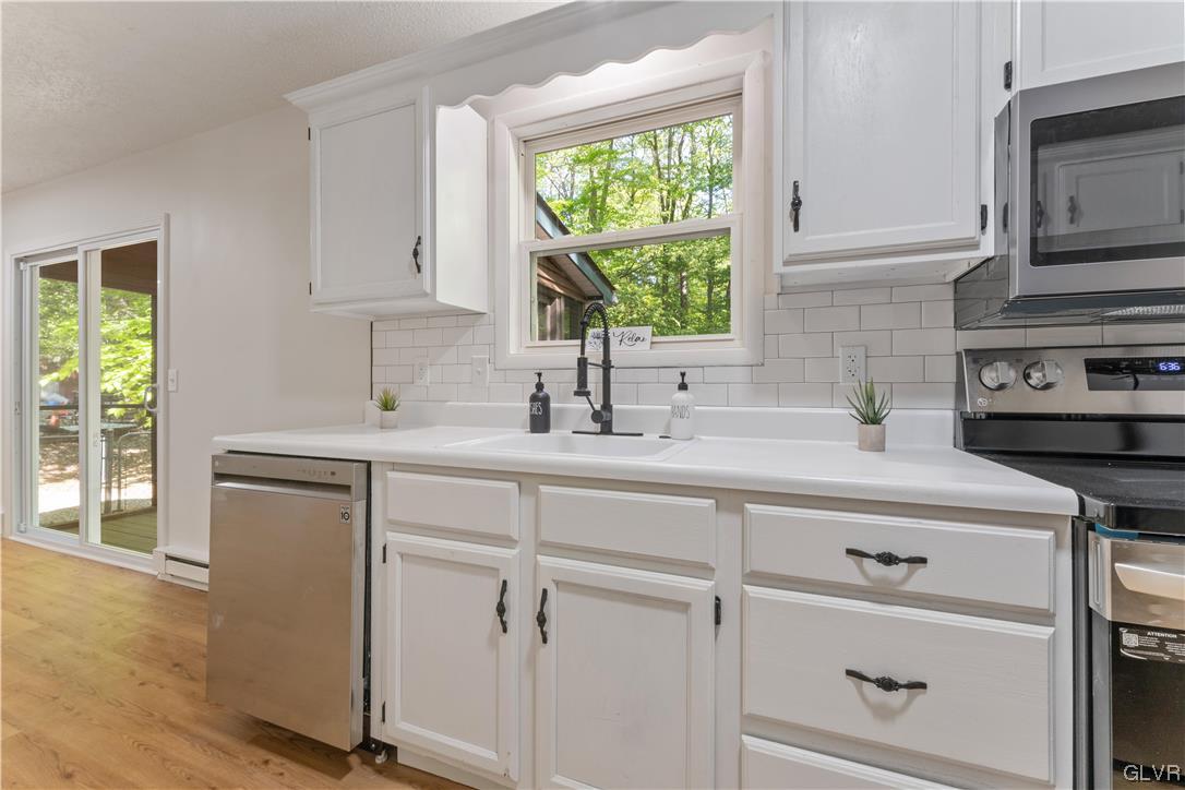4121 Romeo Road Tobyhanna, PA 18466 - Photo 8 of 24 a kitchen with white cabinets and a window