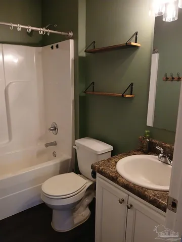 a white toilet sitting next to a bath tub